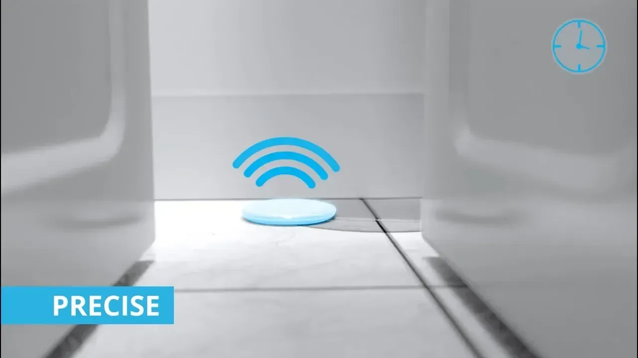 Wireless leak detection sensor positioned precisely on a tiled floor illustrating real-time monitoring